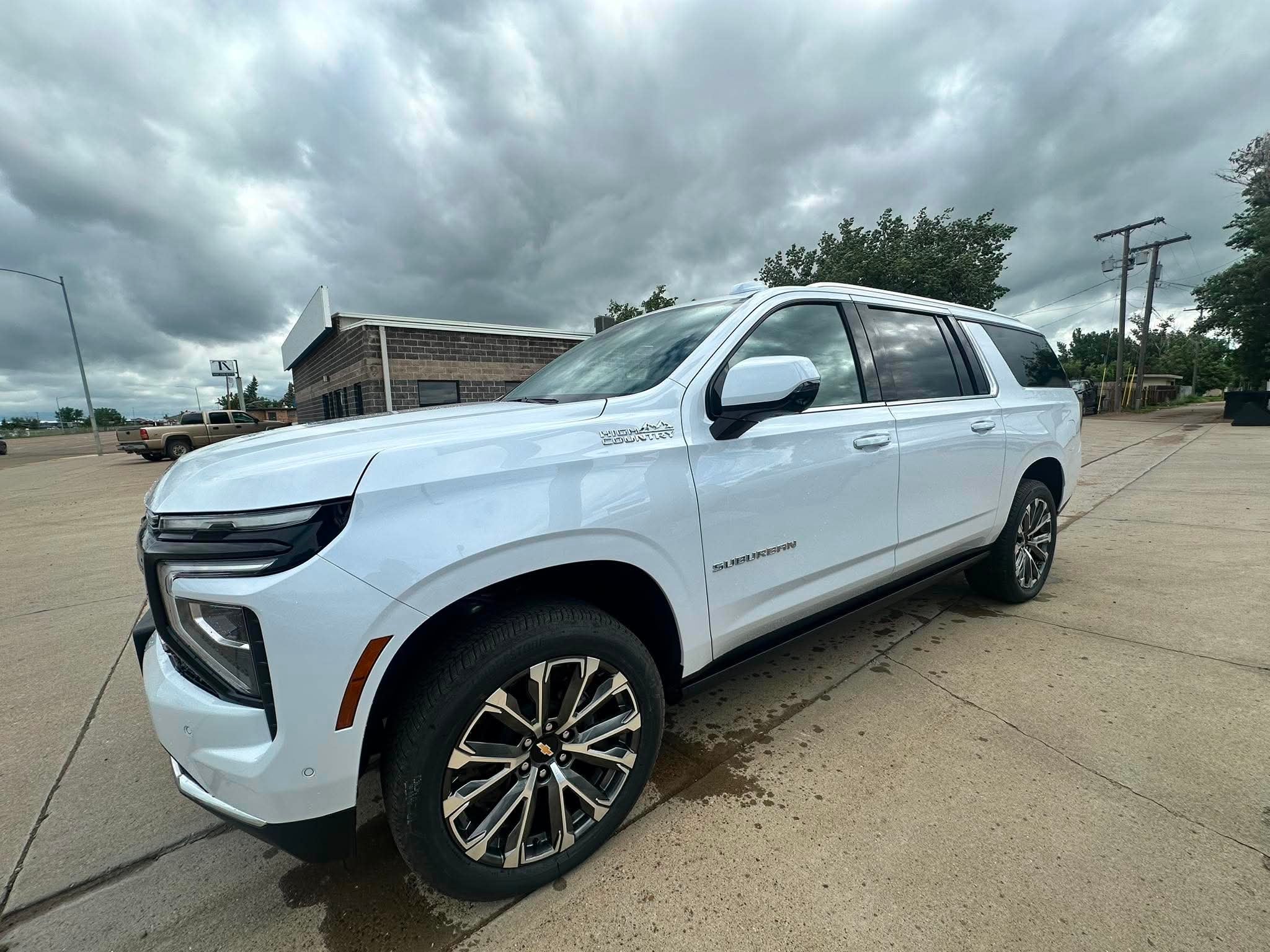 2026 Chevrolet Suburban High Country in Polar White Tricoat — front three-quarter view
