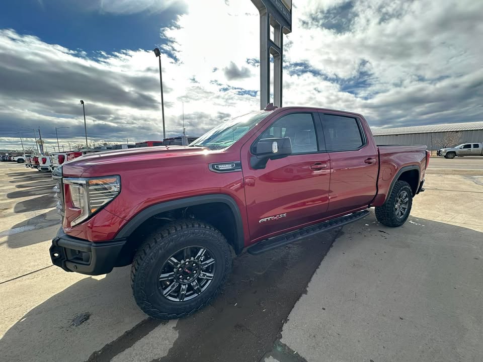 2026 GMC Sierra 1500 AT4X in Volcanic Red Tintcoat — front three-quarter view