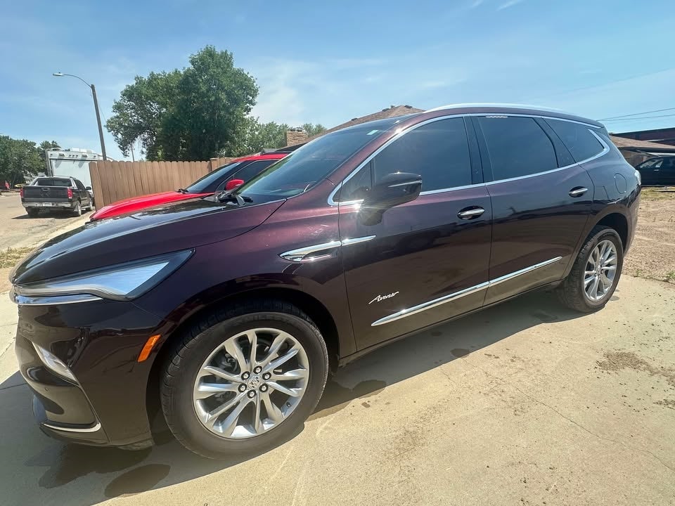 2023 Buick Enclave Avenir in Rich Garnet Metallic — front three-quarter view